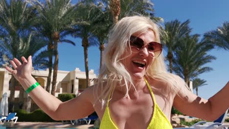 head shot woman video chat near palm trees