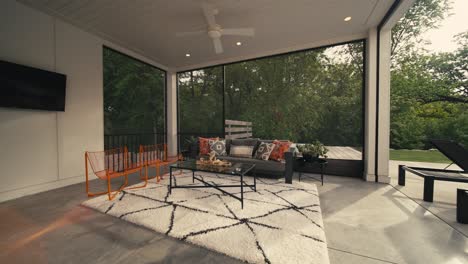 a covered outdoor living space area at a luxury home next to a pool