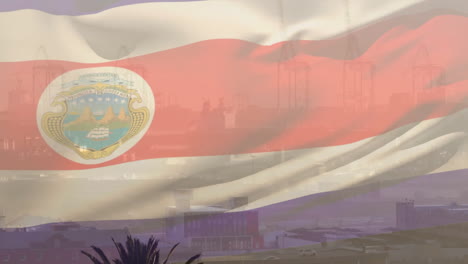 costa rica flag waving over industrial port, cranes and buildings in background
