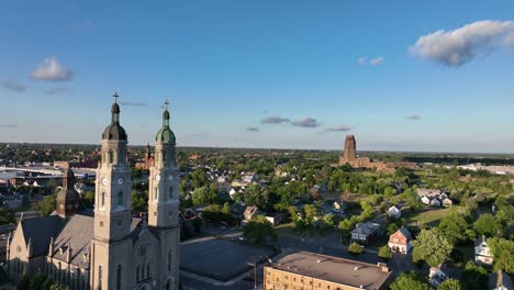 An-aerial-view-of-the-Saint-Stanislaus-B-and-M-Roman-Catholic-Church-spires-in-Buffalo,-New-York-in-the-light-of-the-setting-sun