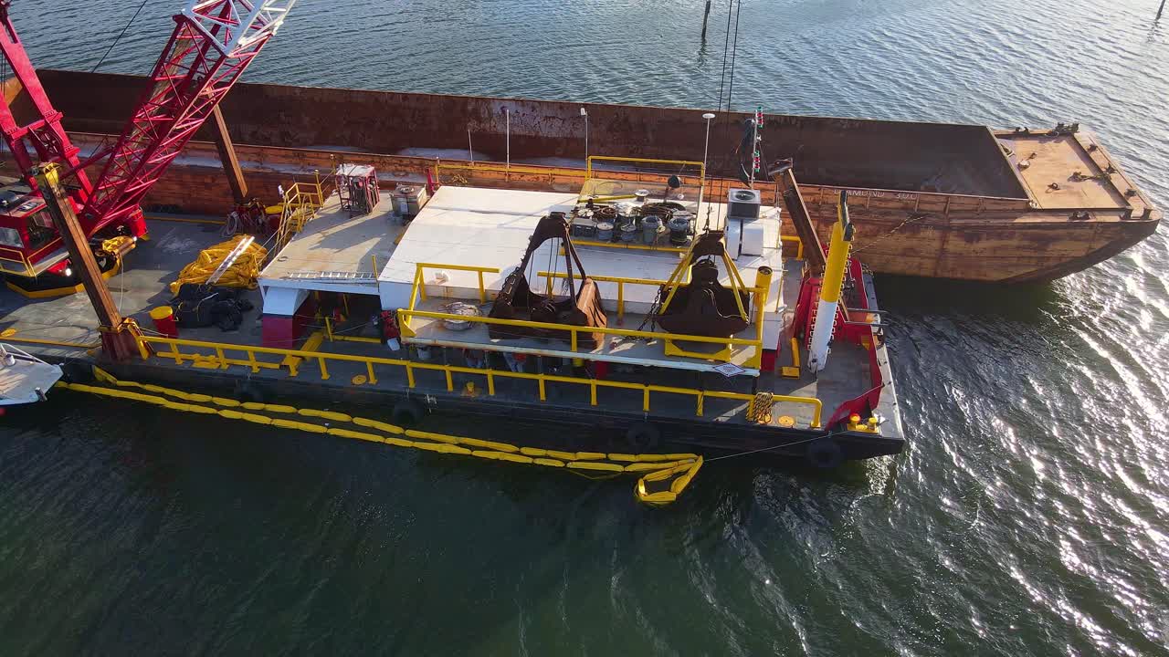 Dredging barge operating near Anclote River Park, Florida in a waterway, USA