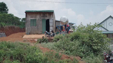 small house and water tank on a hill