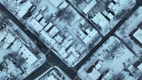 aerial birds eye view of homes covered in snow