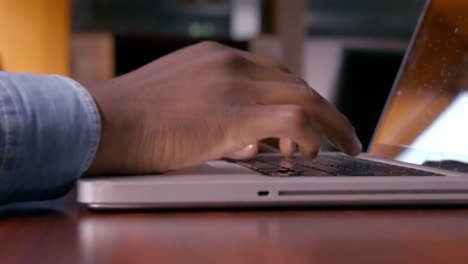 mans hands using laptop