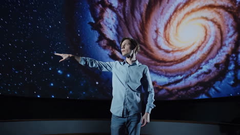 man experiencing a galaxy projection in a planetarium