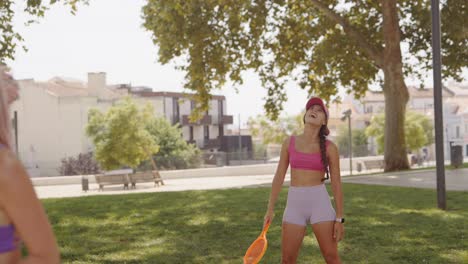 Women playing beach tennis in the park