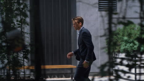 focused businessman running late on corporate meeting in modern office building.