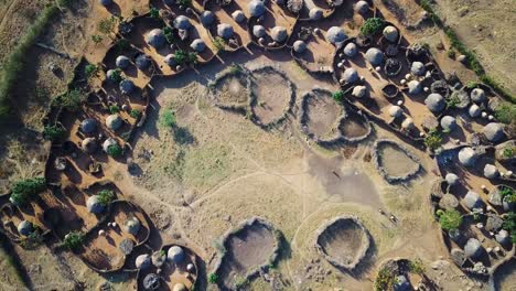 aerial drone zoom out view from the center of a village in the karamoja region, also called manyatta or ere, in uganda, during a sunny day