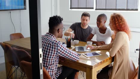 Front-view-of-young-mixed-race-business-team-planning-and-sitting-in-meeting-room-in-office-4k