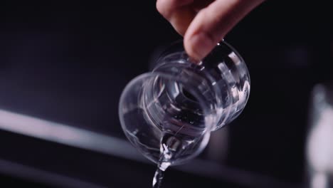 pouring water from a glass beaker