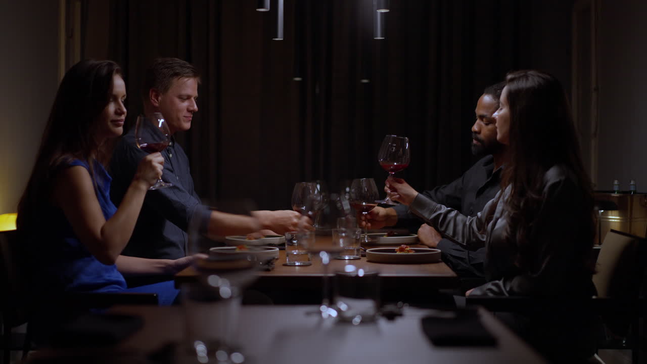 People enjoying dinner and wine at a restaurant