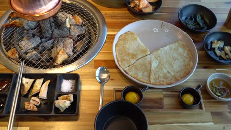 korean traditional chicken bbq restaurant with many side dishes - pajeone , egg yolks, pickled onion and paper and kimchi