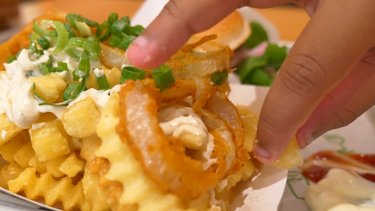 Loaded waffle fries with onion rings and green onions