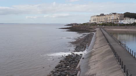 water being released from the artificial beach in weston-super-mare into the sea, waves crushing into the rocky beach