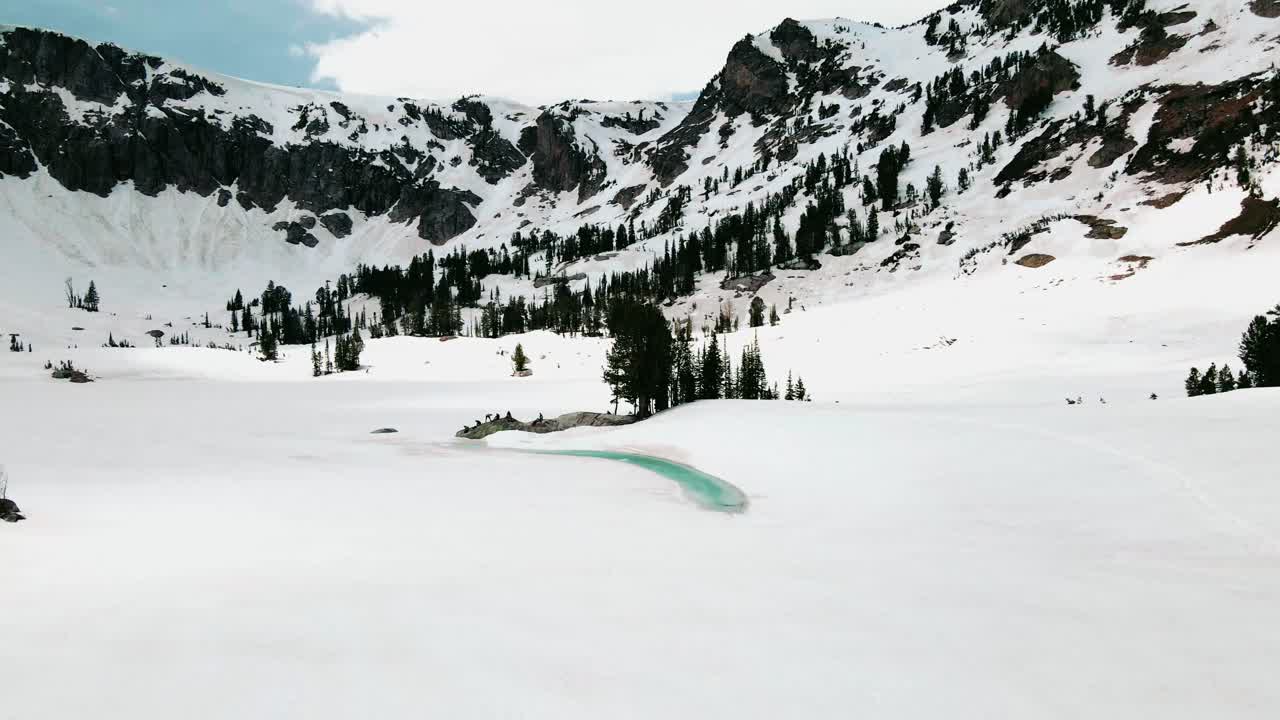 group of people hiking on harsh condition through mountains