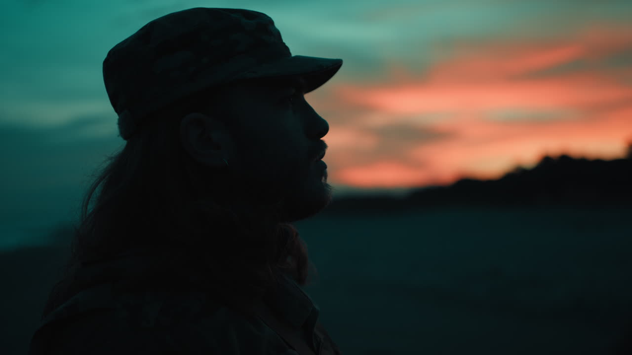 Memorial Day soldier salutes the fallen at sunset in silhouette American