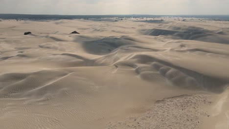 aerial flyover australian sandy desert during sunny day and cloudy day