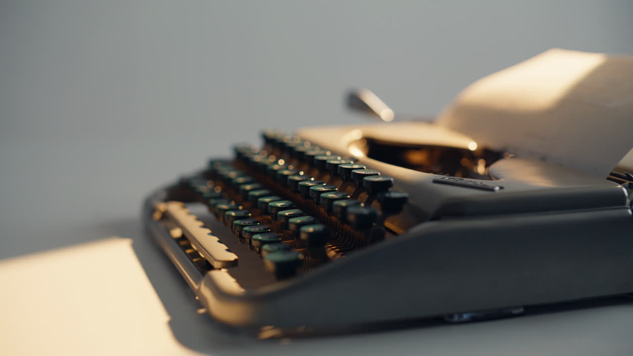 Closeup vintage typewriter keys in well-lit room. Classic black type equipment