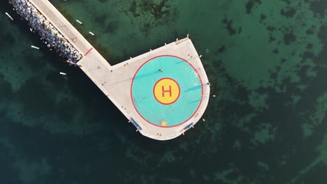 aerial view helicopter landing site located in lake near harbor with boat