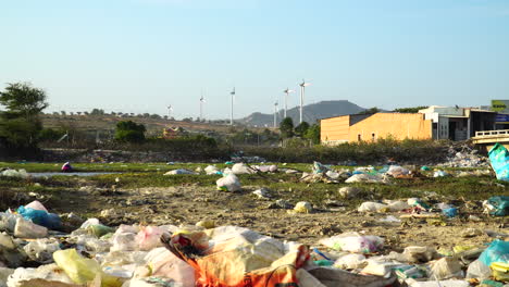 urban scene with scattered garbage, wind turbines in background, vietnam