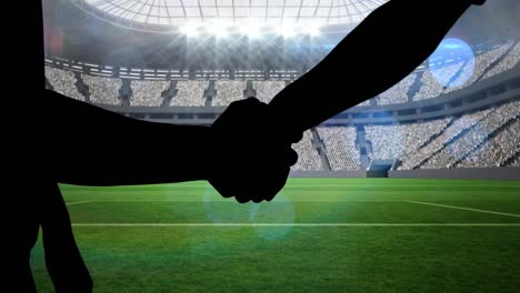 Animation-of-silhouettes-of-players-shaking-hands-over-sports-stadium