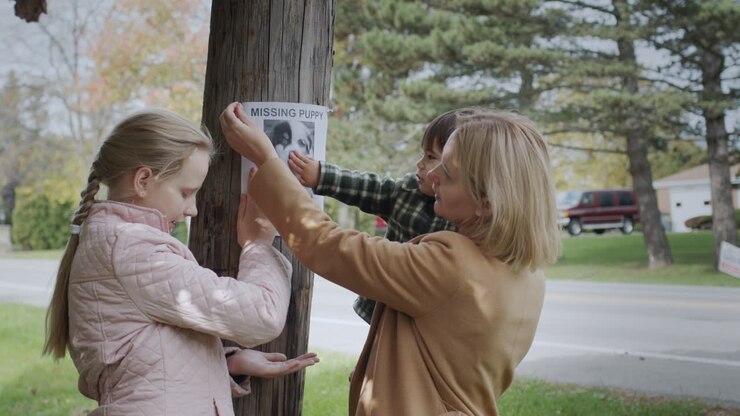 A woman with children pastes ads about a missing puppy
