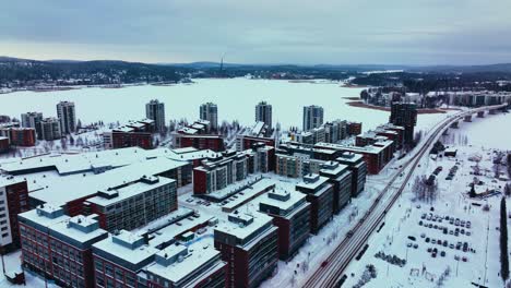 aerial view overlooking apartments and condos in lutakko, jyvaskyla, winter evening in finland - tracking, drone shot