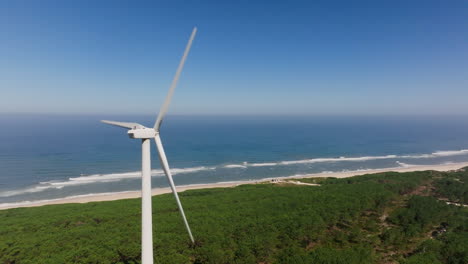 coastal wind turbine with beach and forest view