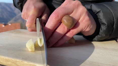 chopping garlic on a wooden board