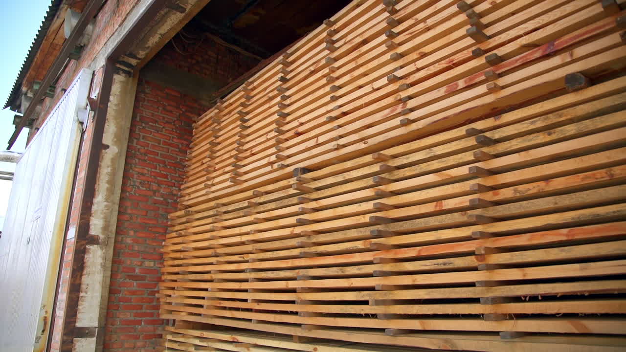 The pile of timber bricks stored in the warehouse. Materials prepared for wood products manufacturing.