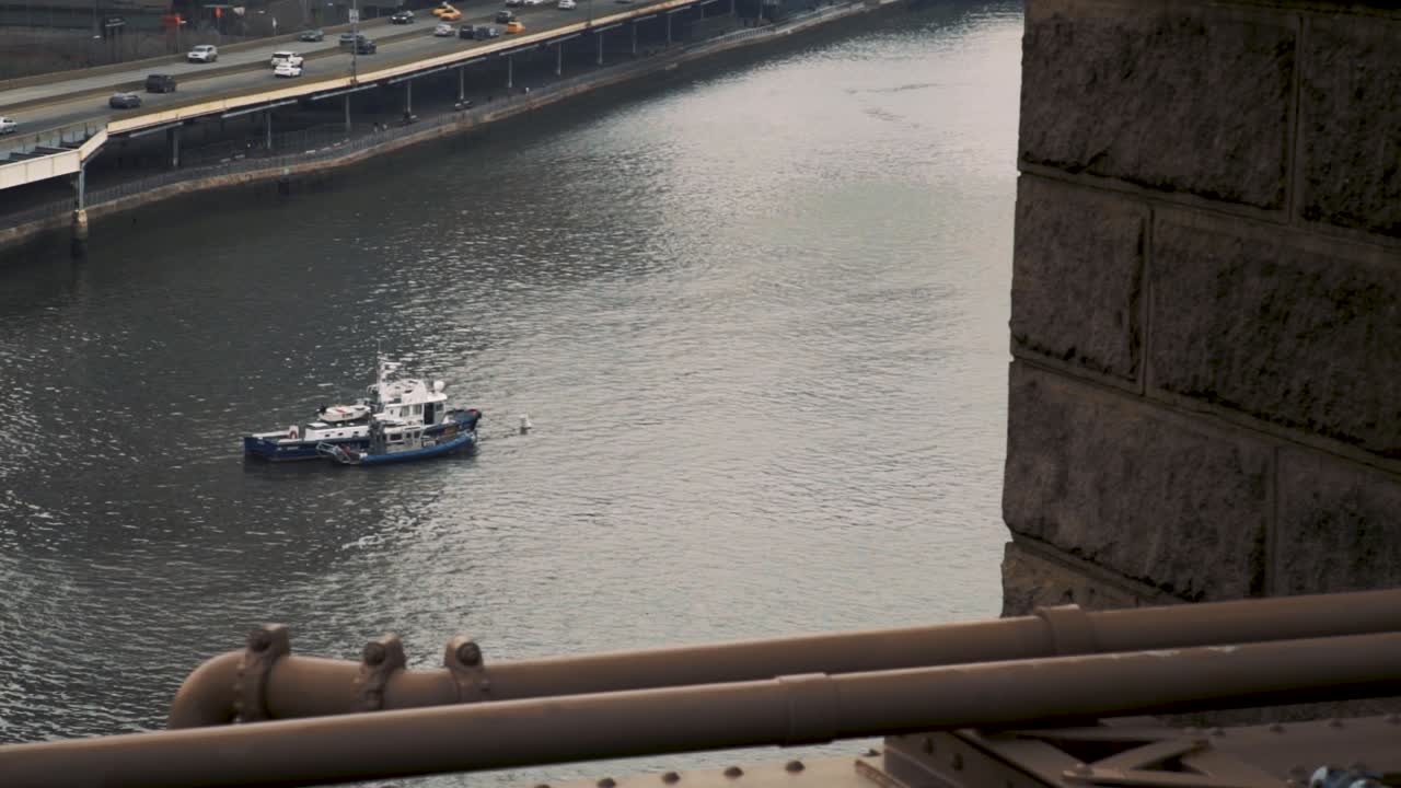 Slow motion view of a boat still, anchored boat from Brooklyn Bridge, New York 1080p