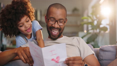 father and child celebrating father's day with a handmade card