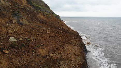 Side-View-Along-Large-Coastal-Cliff-Fall-at-Seatown-Beach