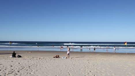 people playing volleyball on a sandy beach