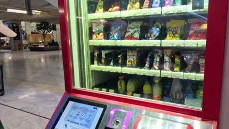 sequence of a man selecting a drink from a digital machine