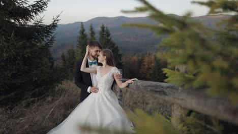 newlyweds. caucasian groom with bride on mountain slope. wedding couple. happy