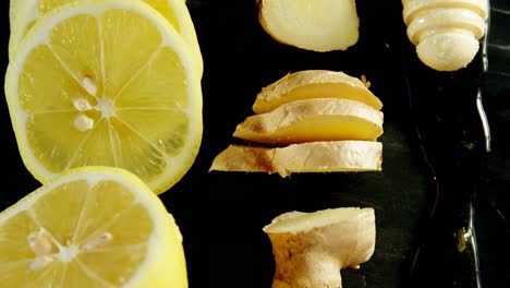 lime, ginger and honey dipper in black background 4k