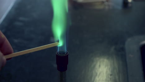 close up of blue bunsen burner flame followed by copper flame test burning green