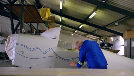 engineer marking a line on airplane parts 4k