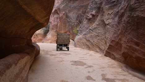 horse carriage riding through the siq canyon to al-khazneh (the treasury), petra, jordan