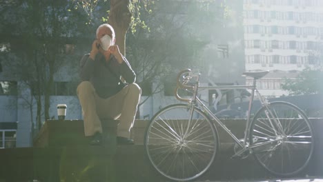 caucasian man out and about in the street wearing on a face mask against coronavirus