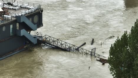 aerial footage highlights a partially submerged restaurant on river