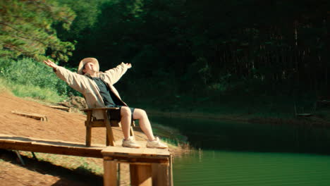 woman relaxing on a dock by a lake
