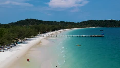 Aerial-pan-along-wooden-pier-on-4k-Beach,-Koh-Rong,-Cambodia