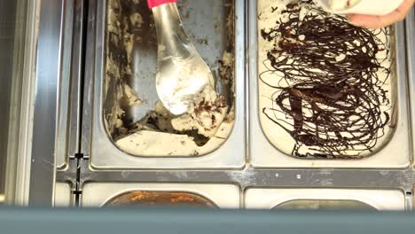 Hand-picking-ice-cream-with-a-spoon-from-a-bowl