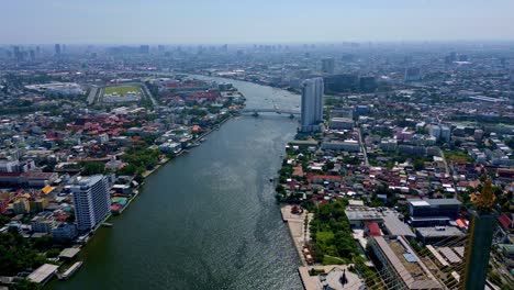 rama viii bridge single pylon on thonburi bank of chao phraya river in bangkok, thailand. aerial pullback reveal