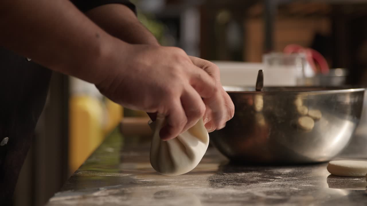 Homemade khinkali dumplings, traditional georgian food, closeup on hands