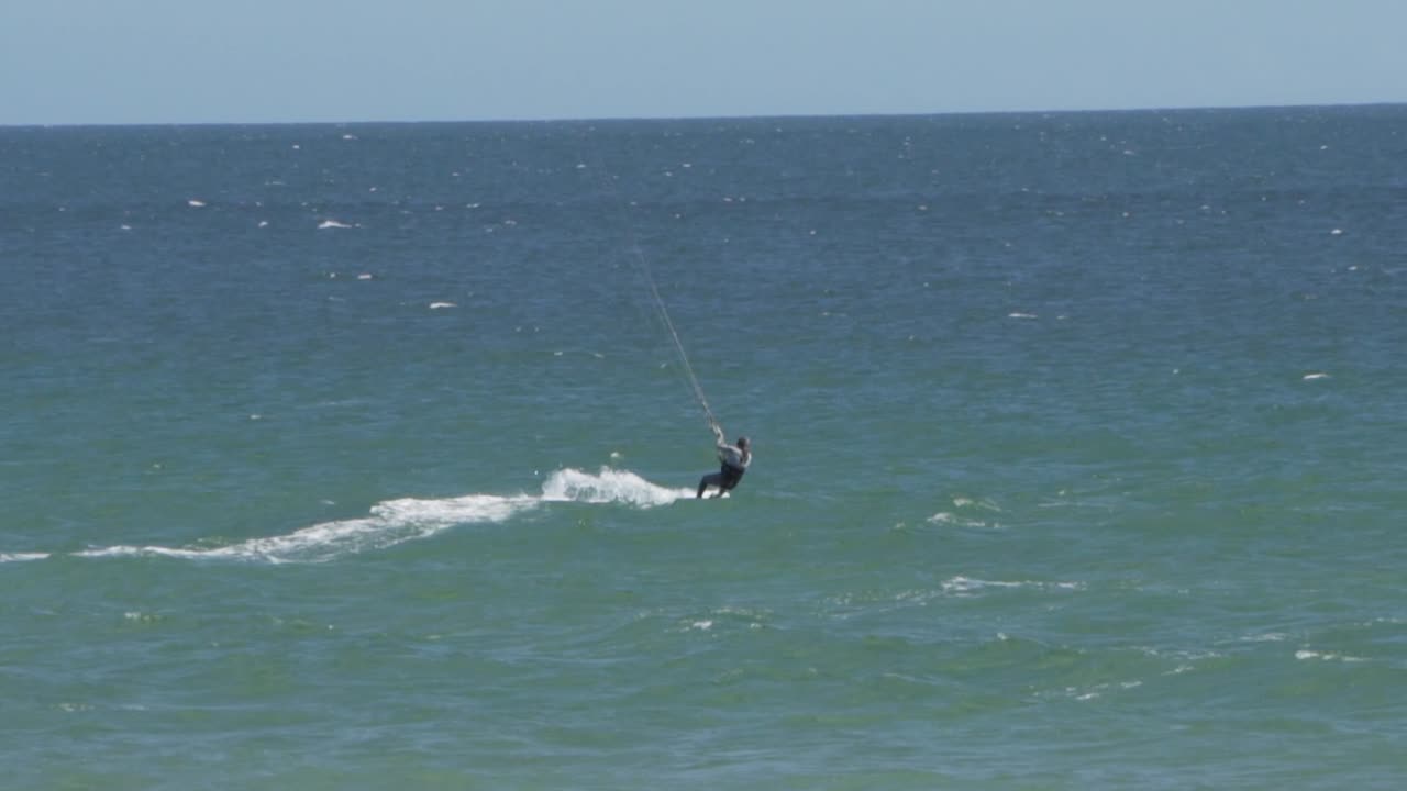 A man doing kit surf