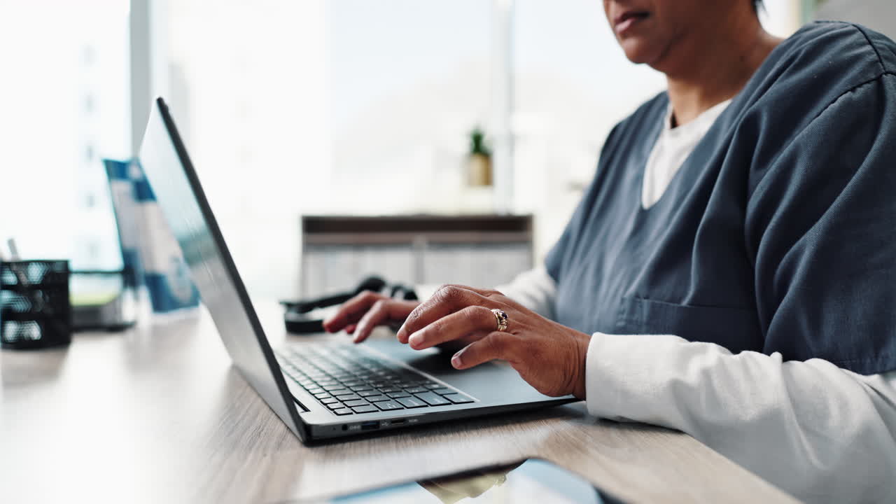 Nurse working on laptop in office