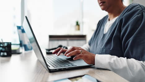 nurse working on laptop in office